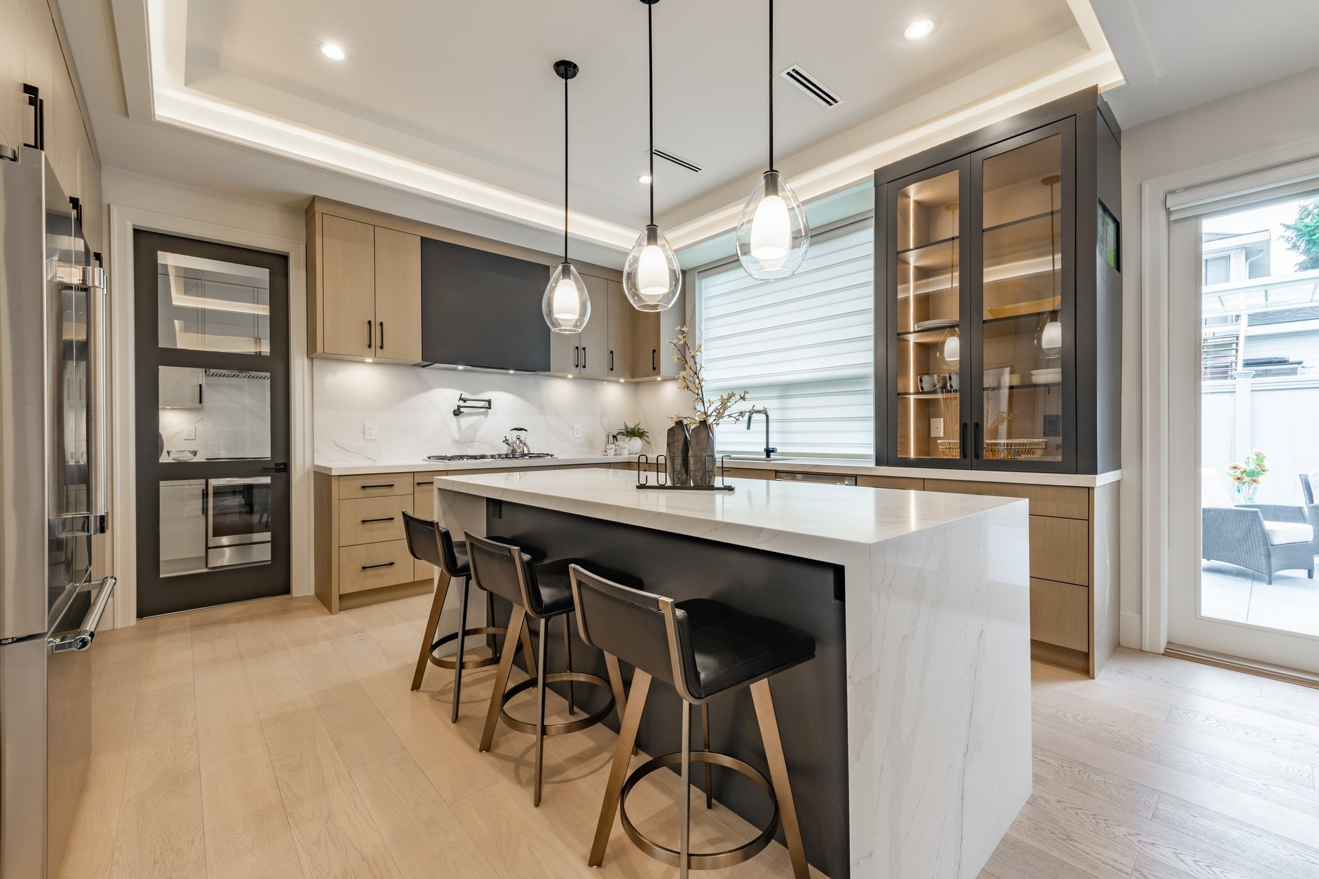 Kitchen interior with bar stools white countertops wooden cabinets pendant lighting